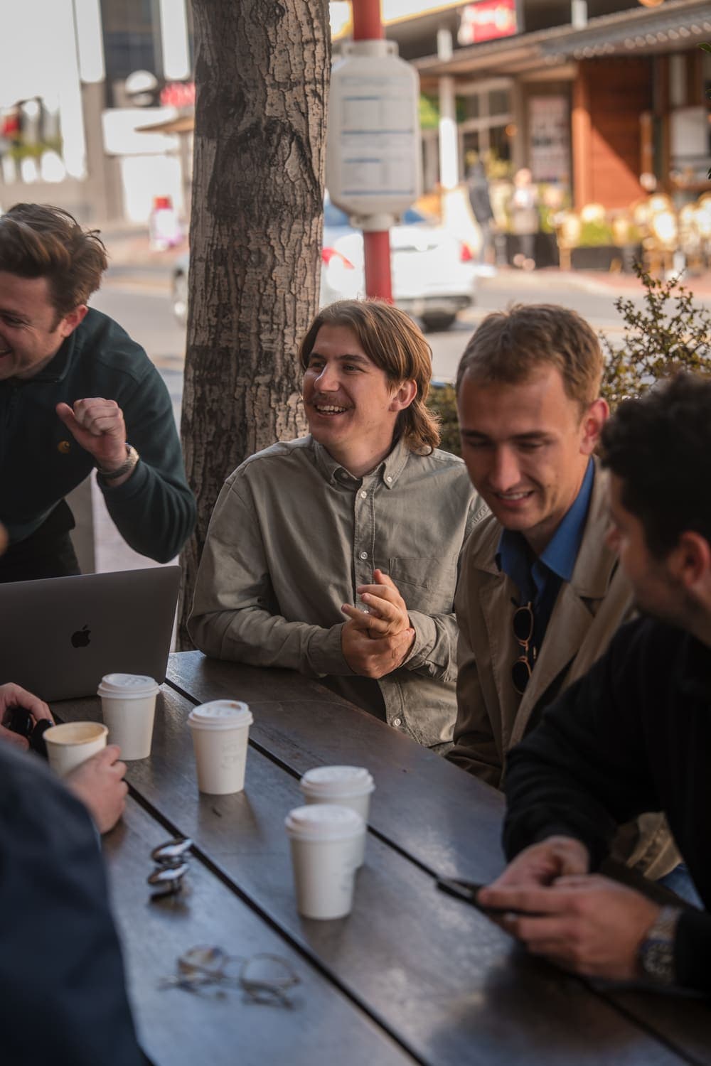 The Unyfy team working from a sidewalk cafe