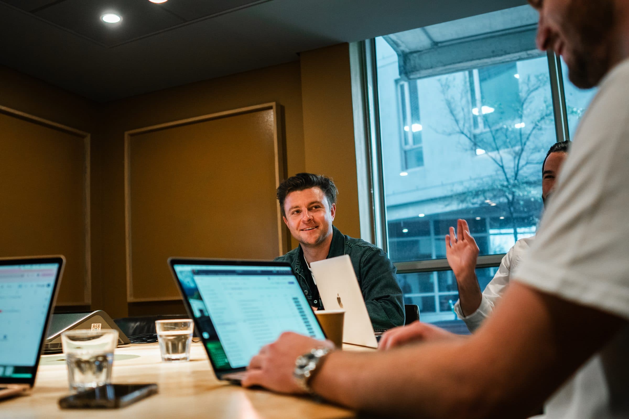 The Unyfy team working together around the boardroom table