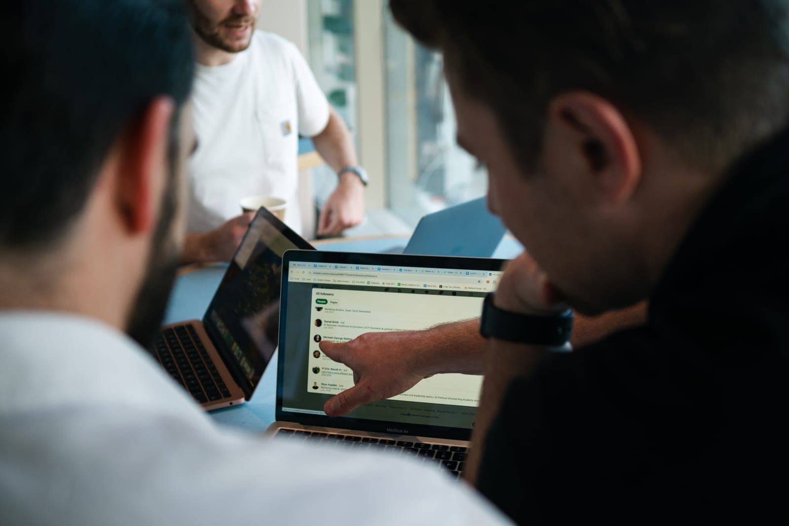 The Unyfy team reviewing a client's audience growth on a laptop